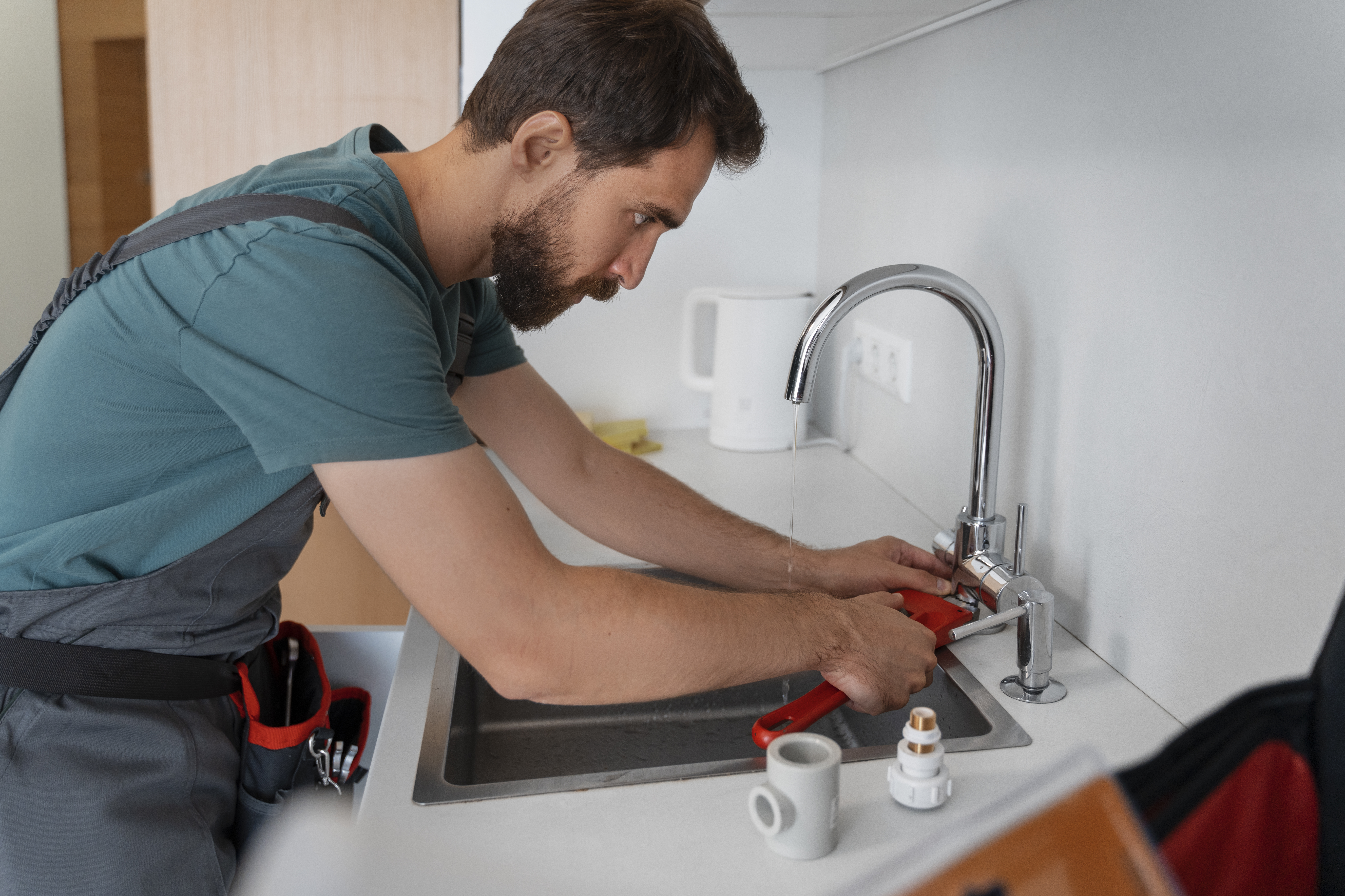 Plumber using tools to carry out blocked drain services